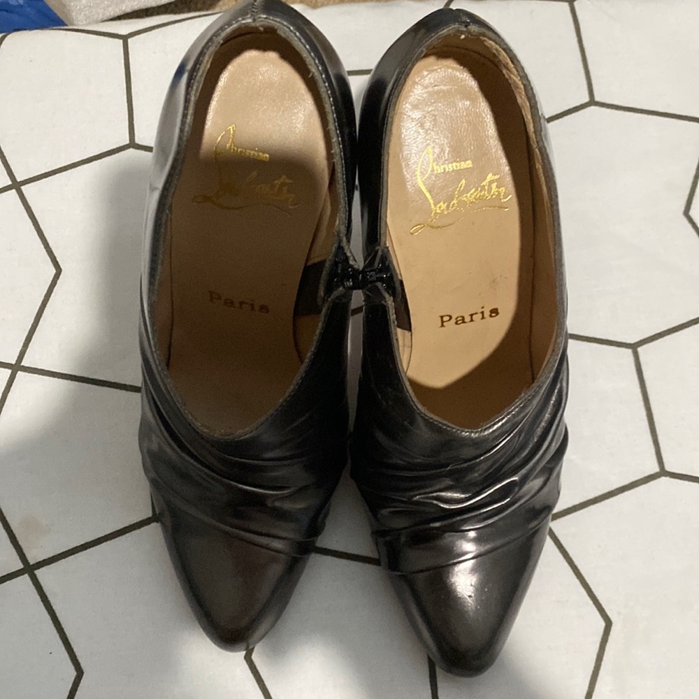 Signed Christian Louboutin silver booties.